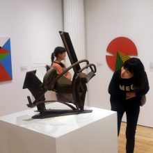 Maiko Jinushi examining a Mark di Suvero sculpture
