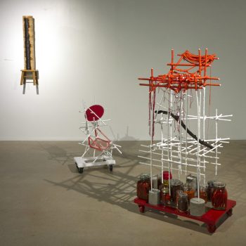 Sandra Eula Lee, "L to R: Backbone; Habitat; The Walking Mountain (Ferment/Foment)", 2021; Steamers, stool, saw blade, woven yarn, charred wood branch, bamboo stakes, plaster, blown glass, sealed containers of fermenting peppers, red chili pepper powder, sulphur powder, rolling pallet