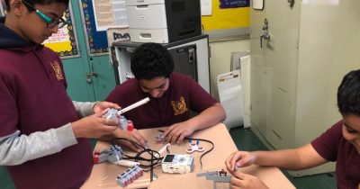 Students from MS136 Robotics class collaborating to build their Lego piece based on their personal object