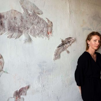 Jana Zatvarnická with her work "Birds,’’ dimensions variable, egg-tempera on transparent paper, 2024. Photo credit: Xheni Cuni